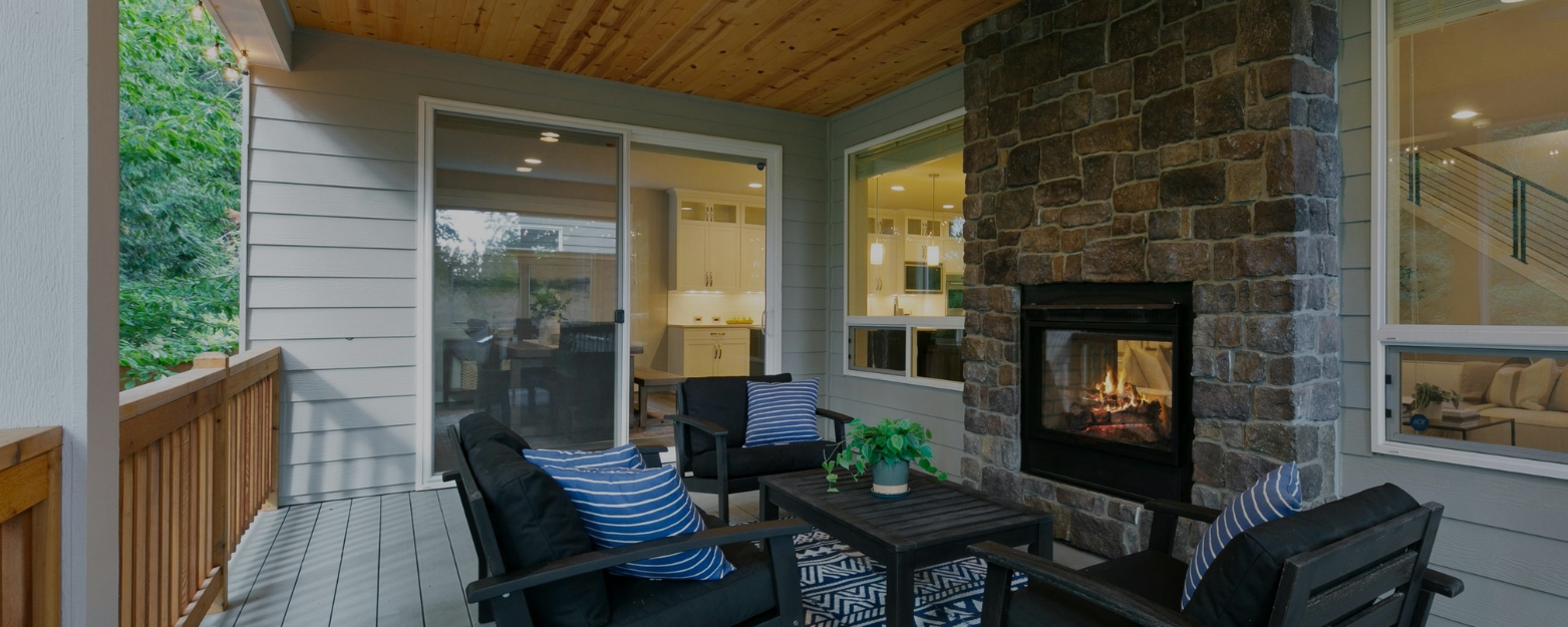 Beautiful outdoor stone fireplace on a covered patio, built by expert Seattle masonry contractors