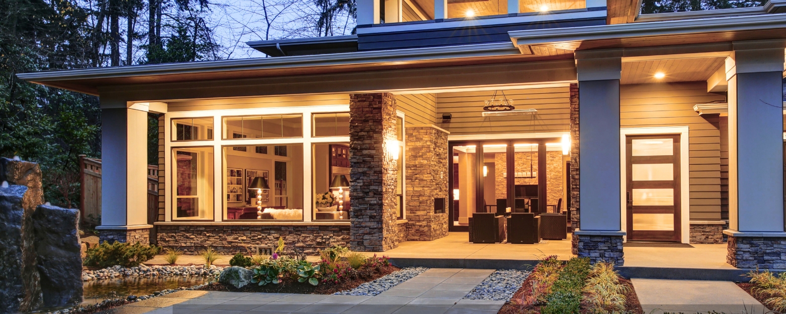 Expertly crafted stone veneer columns and siding on a high-end Issaquah home, showcasing premium masonry craftsmanship.